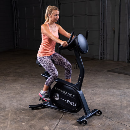 Body-Solid Endurance B4UB Upright Bike with woman riding