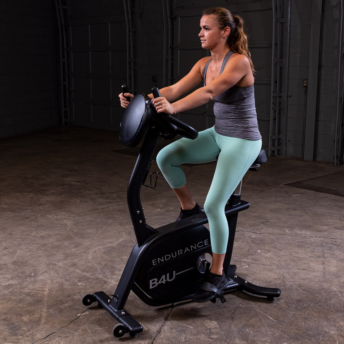 Body-Solid Endurance B4UB Upright Bike with woman riding