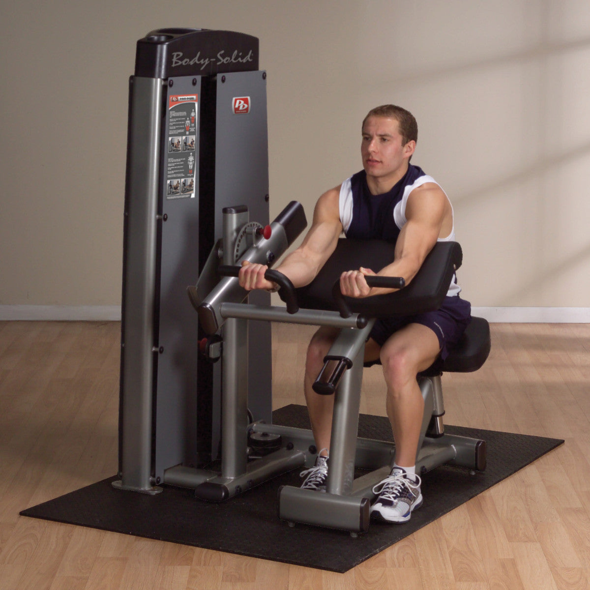 Body-Solid DBTCSF ProDual Biceps Triceps Machine man exercising