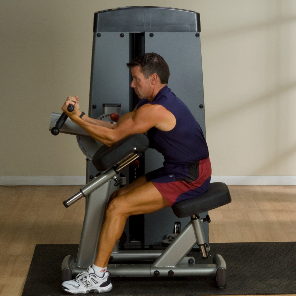 Body-Solid DBTCSF ProDual Biceps Triceps Machine man exercising