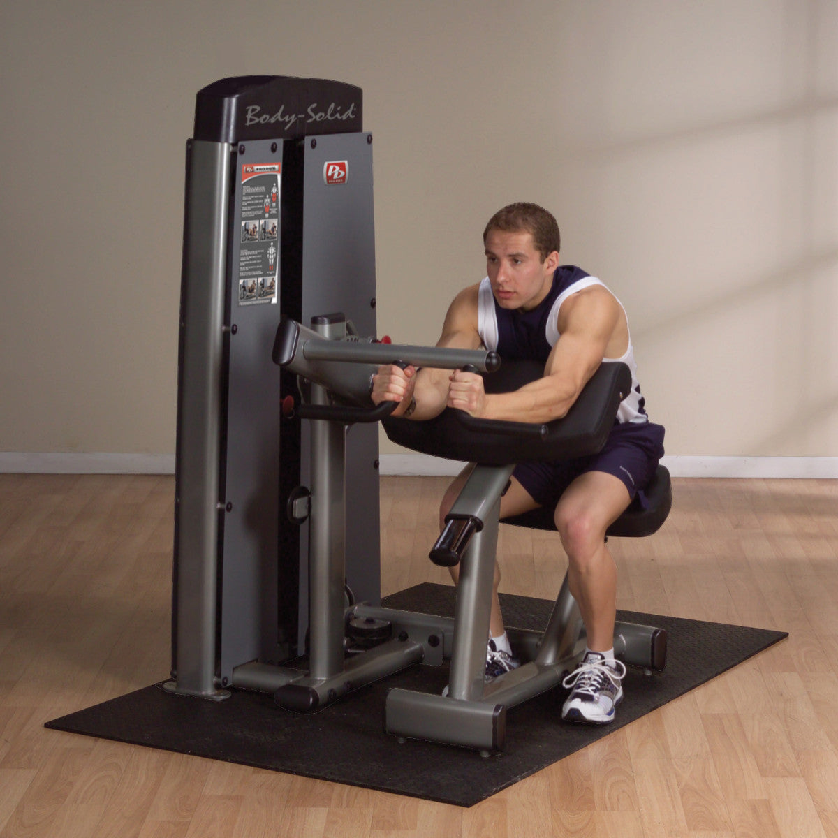 Body-Solid DBTCSF ProDual Biceps Triceps Machine man exercising