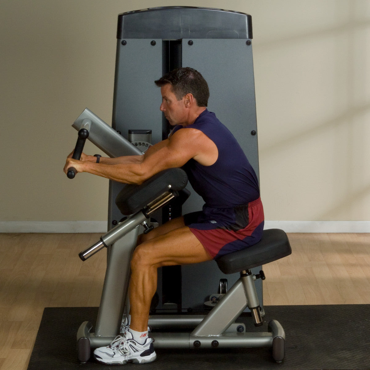 Body-Solid DBTCSF ProDual Biceps Triceps Machine man exercising