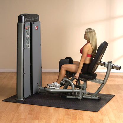 Body-Solid DIOTSF ProDual Inner Outer Thigh Machine in room with woman exercising