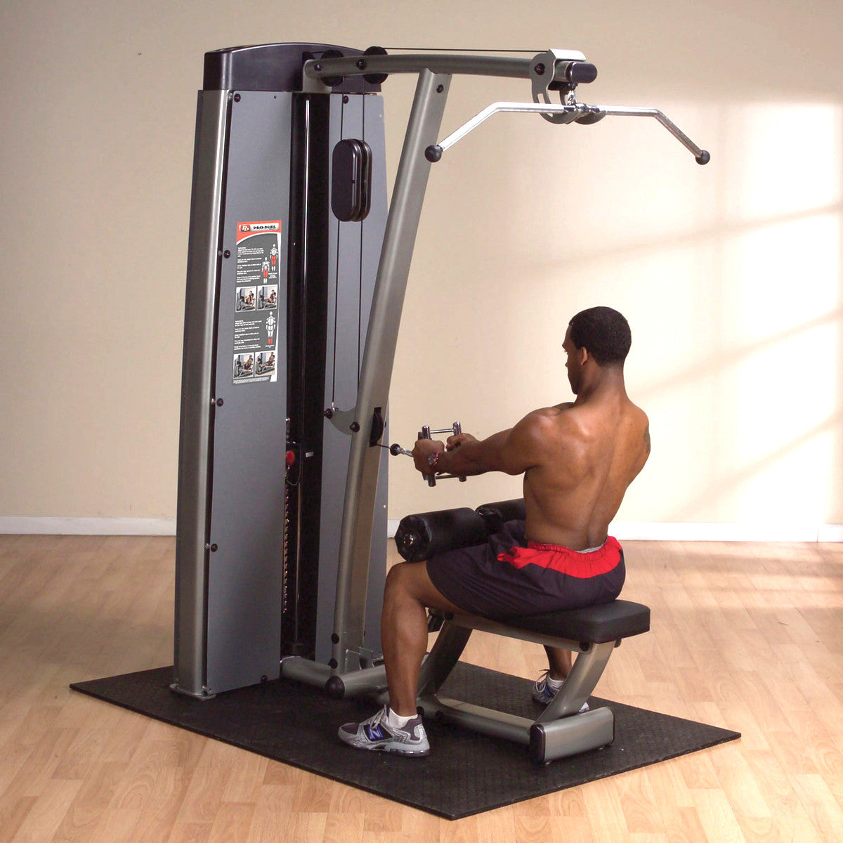Body-Solid DLAT ProDual Lat & Mid Row Machine man exercising in gym