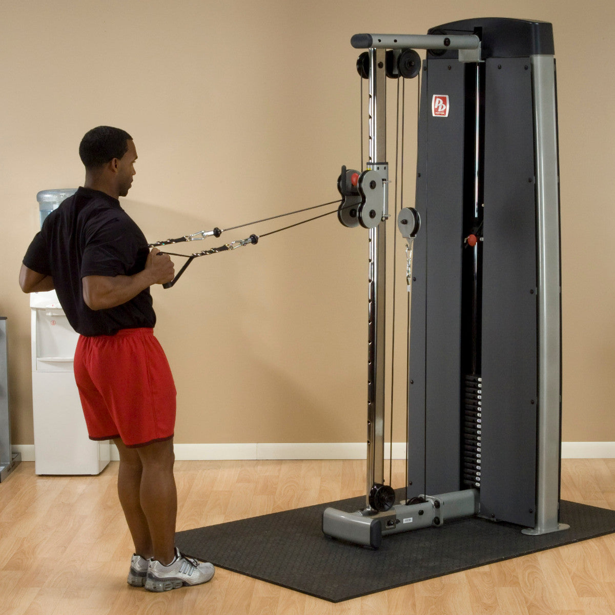 Body-Solid ProDual DPCC Cable Column Machine man exercising