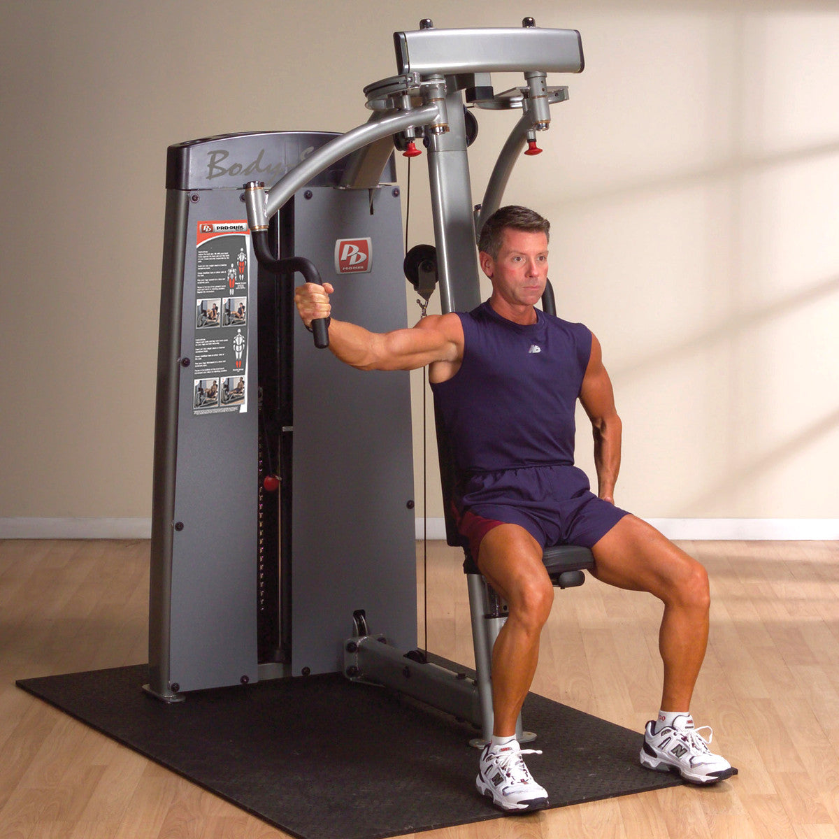 Body-Solid DPECSF ProDual Pec Rear Delt Machine in room man exercising