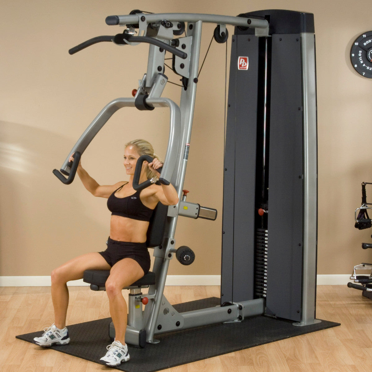 Body-Solid DPLSSF ProDual Press Arm Lat Machine woman exercising