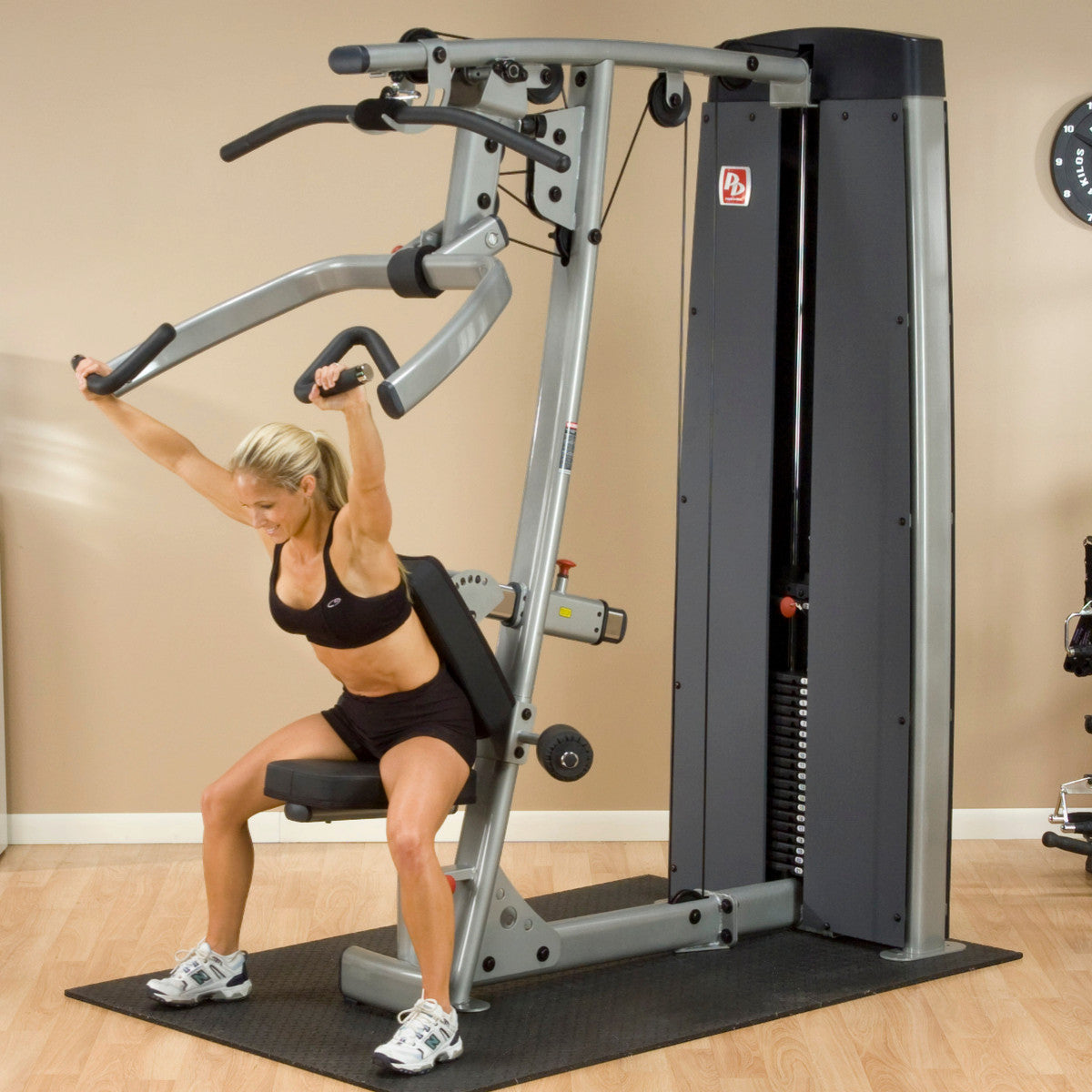 Body-Solid DPLSSF ProDual Press Arm Lat Machine woman exercising