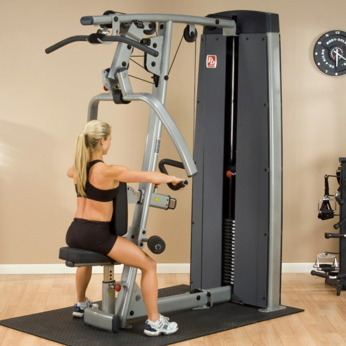 Body-Solid DPLSSF ProDual Press Arm Lat Machine woman exercising