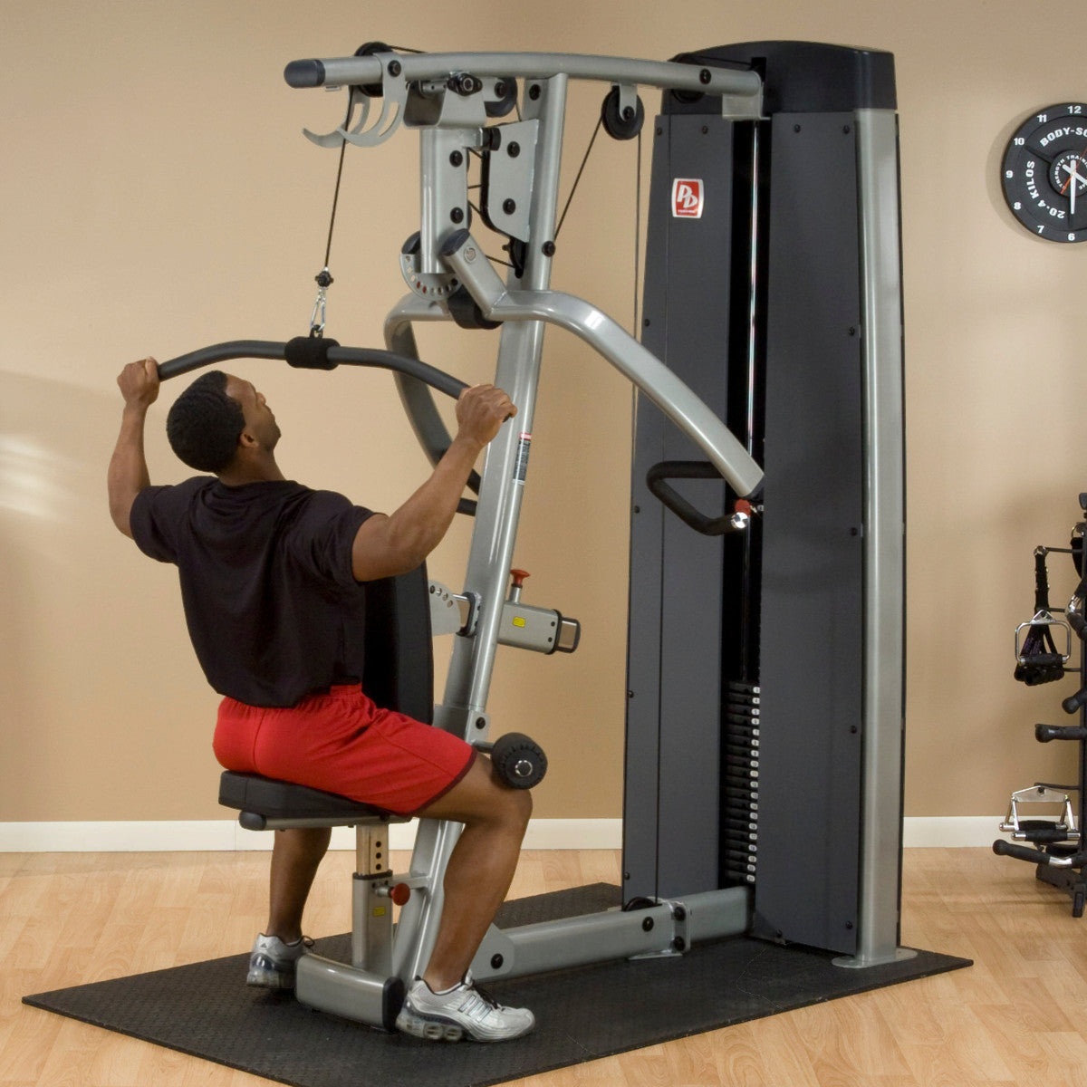 Body-Solid DPLSSF ProDual Press Arm Lat Machine man exercising