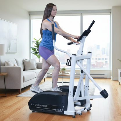 Body-Solid Endurance E100 Center Drive Elliptical Trainer woman exercising in apartment