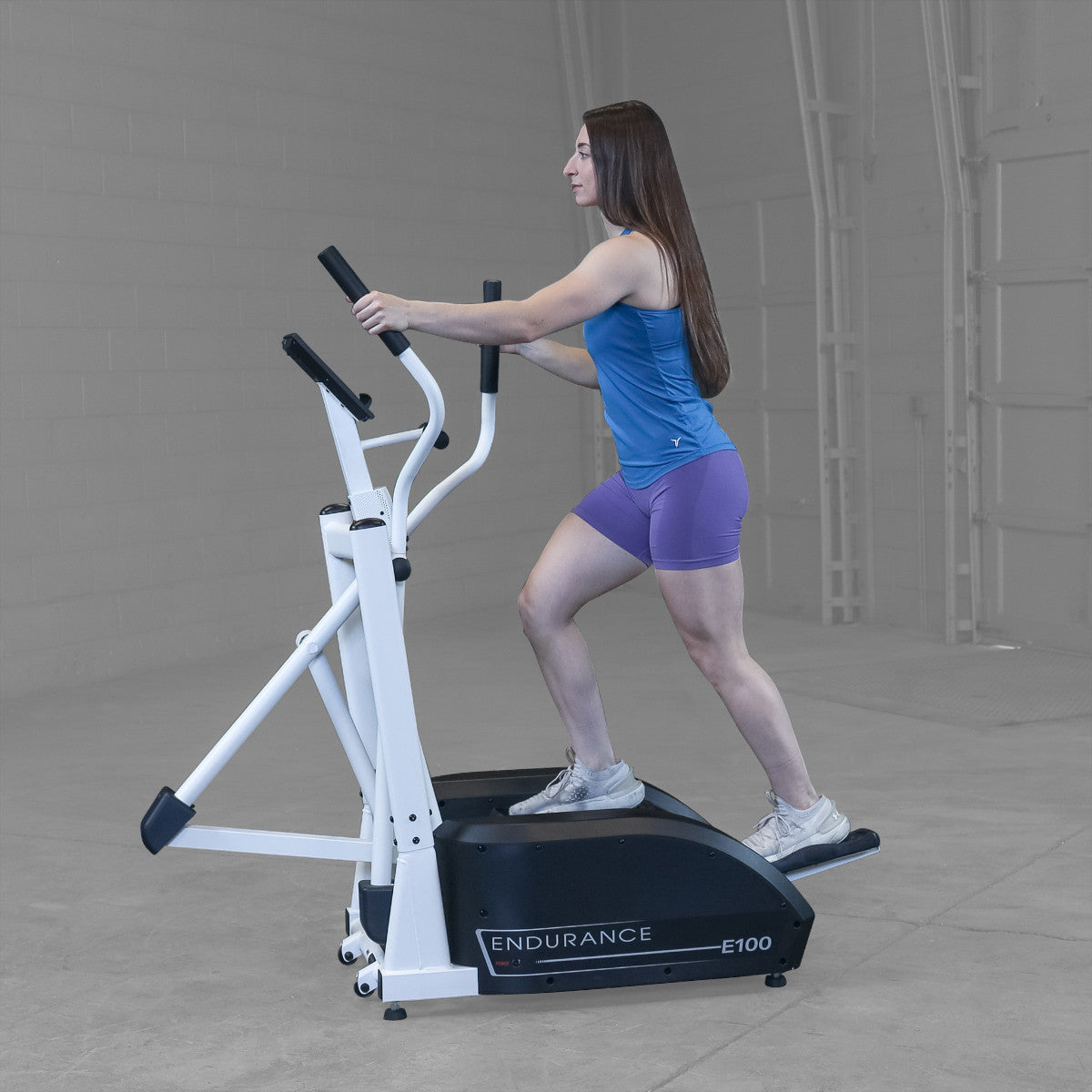 Body-Solid Endurance E100 Center Drive Elliptical Trainer woman exercising