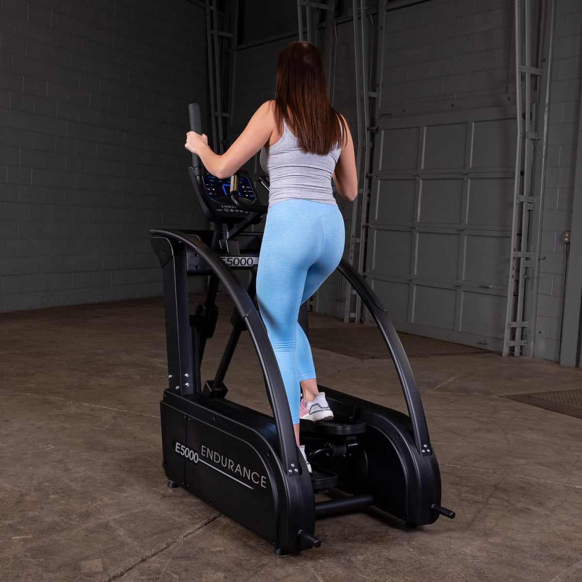 Body-Solid Endurance E5000 Premium Center Drive Elliptical woman exercising