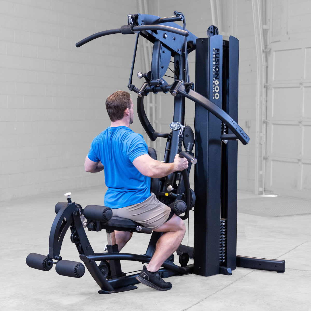 Body-Solid FUSION 600 Bi-Angular Gym with Functional Trainer Arms exercises on white background