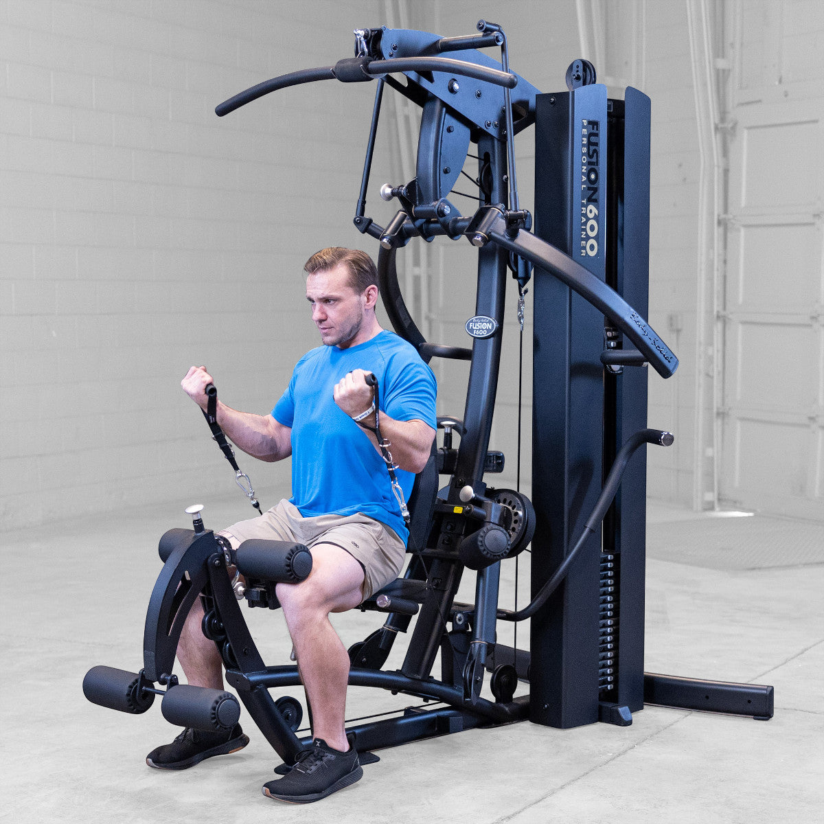 Body-Solid FUSION 600 Bi-Angular Gym with Functional Trainer Arms exercises on white background