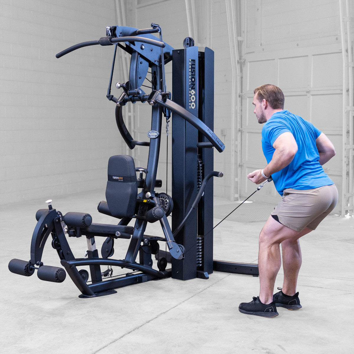 Body-Solid FUSION 600 Bi-Angular Gym with Functional Trainer Arms exercises on white background