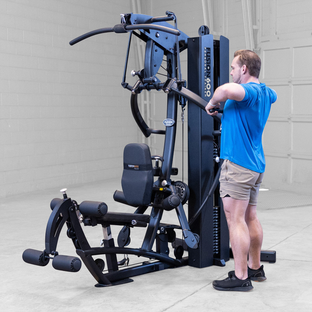 Body-Solid FUSION 600 Bi-Angular Gym with Functional Trainer Arms exercises on white background