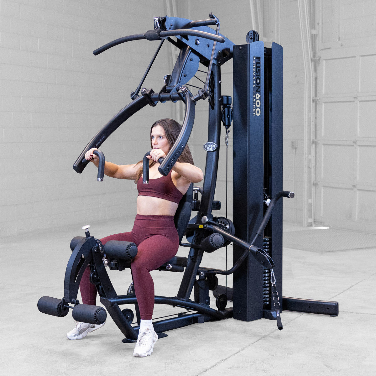 Body-Solid FUSION 600 Bi-Angular Gym with Functional Trainer Arms exercises on white background