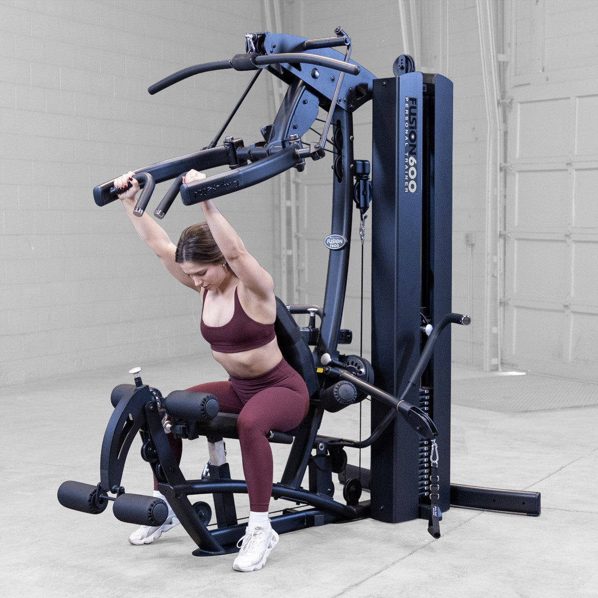 Body-Solid FUSION 600 Bi-Angular Gym with Functional Trainer Arms exercises on white background