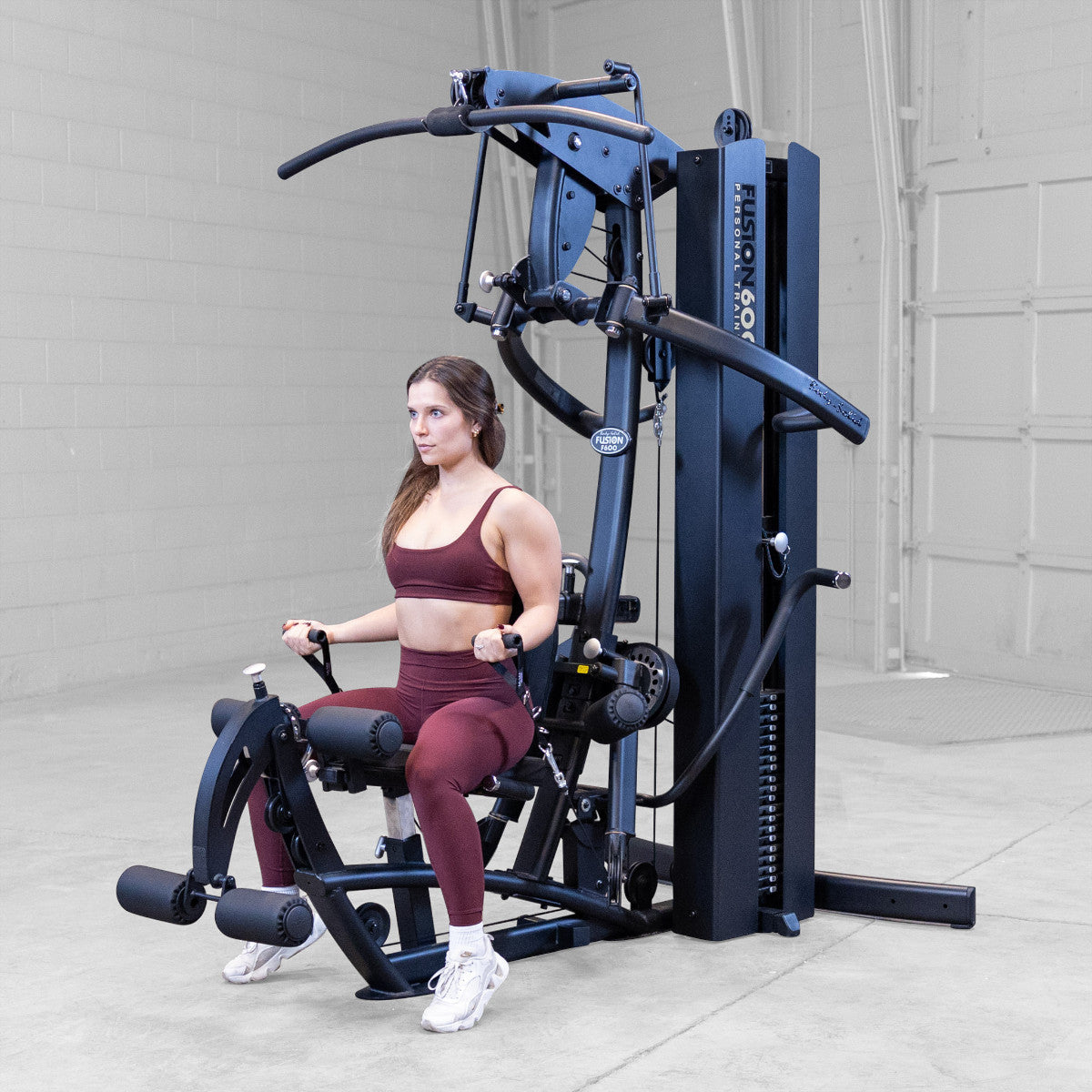 Body-Solid FUSION 600 Bi-Angular Gym with Functional Trainer Arms exercises on white background
