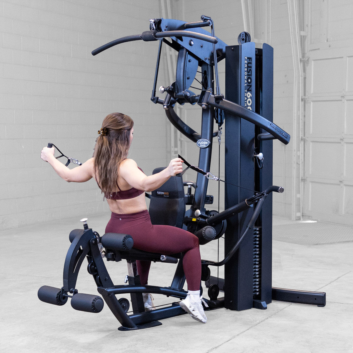 Body-Solid FUSION 600 Bi-Angular Gym with Functional Trainer Arms exercises on white background