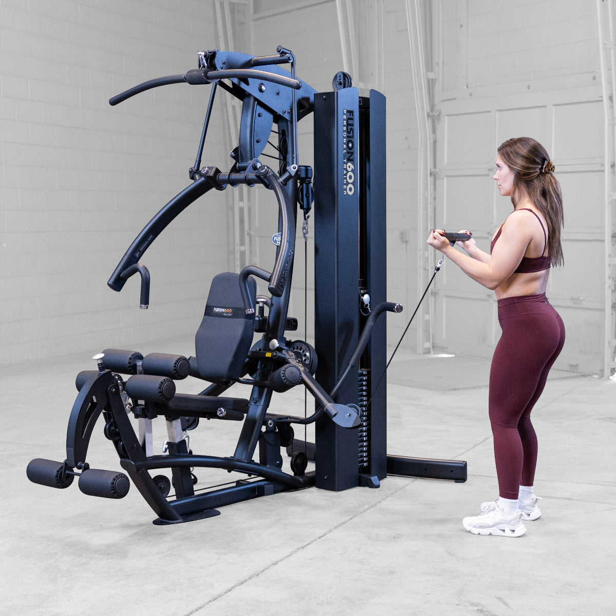 Body-Solid FUSION 600 Bi-Angular Gym with Functional Trainer Arms exercises on white background