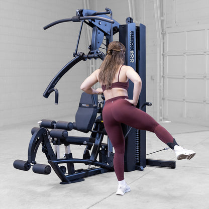 Body-Solid FUSION 600 Bi-Angular Gym with Functional Trainer Arms exercises on white background
