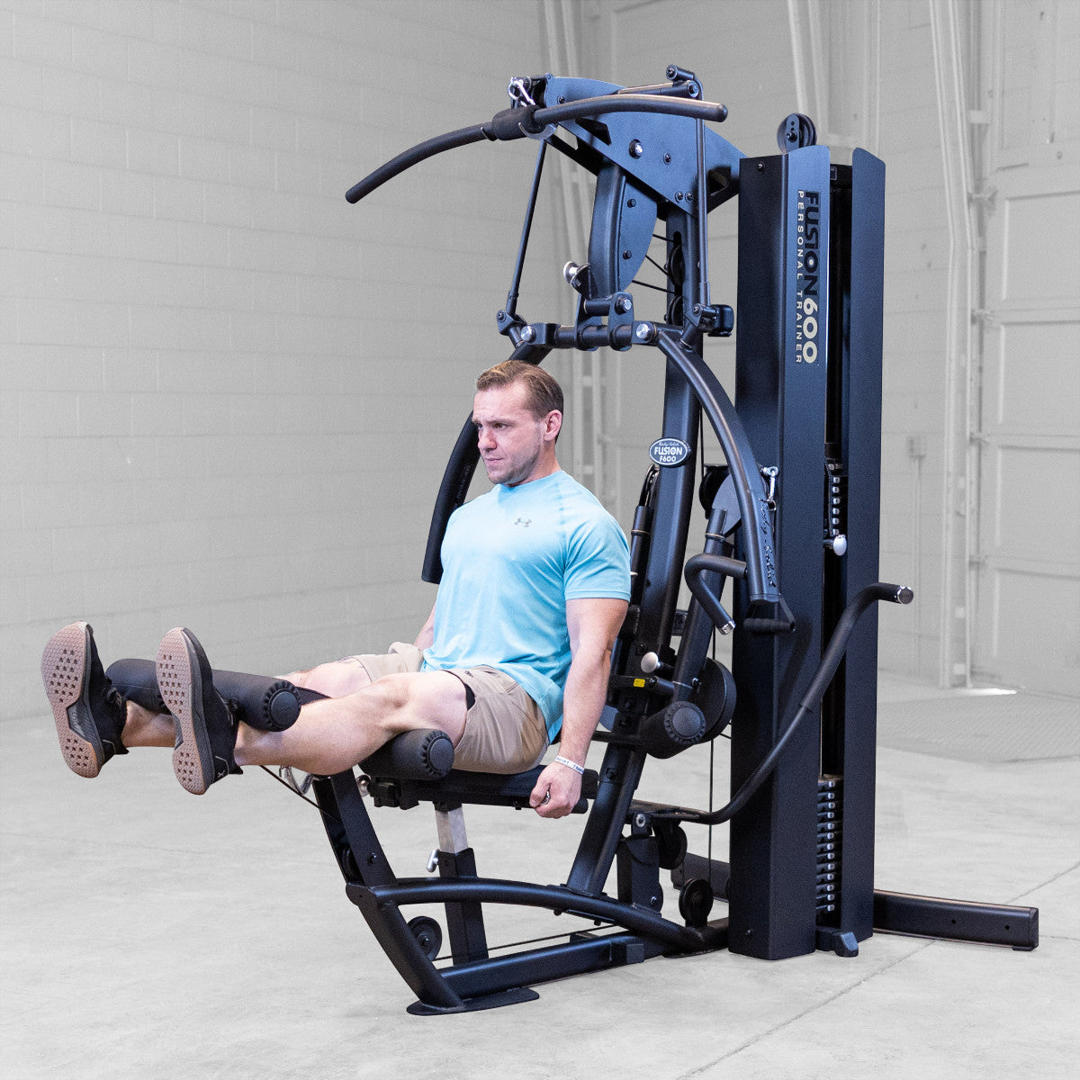 Body-Solid FUSION 600 Bi-Angular Gym with Functional Trainer Arms exercises on white background