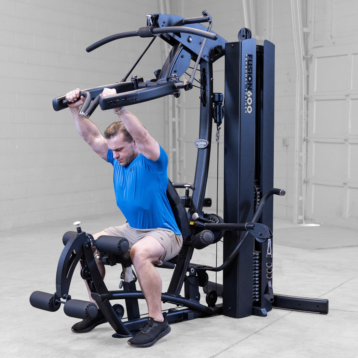 Body-Solid FUSION 600 Bi-Angular Gym with Functional Trainer Arms exercises on white background