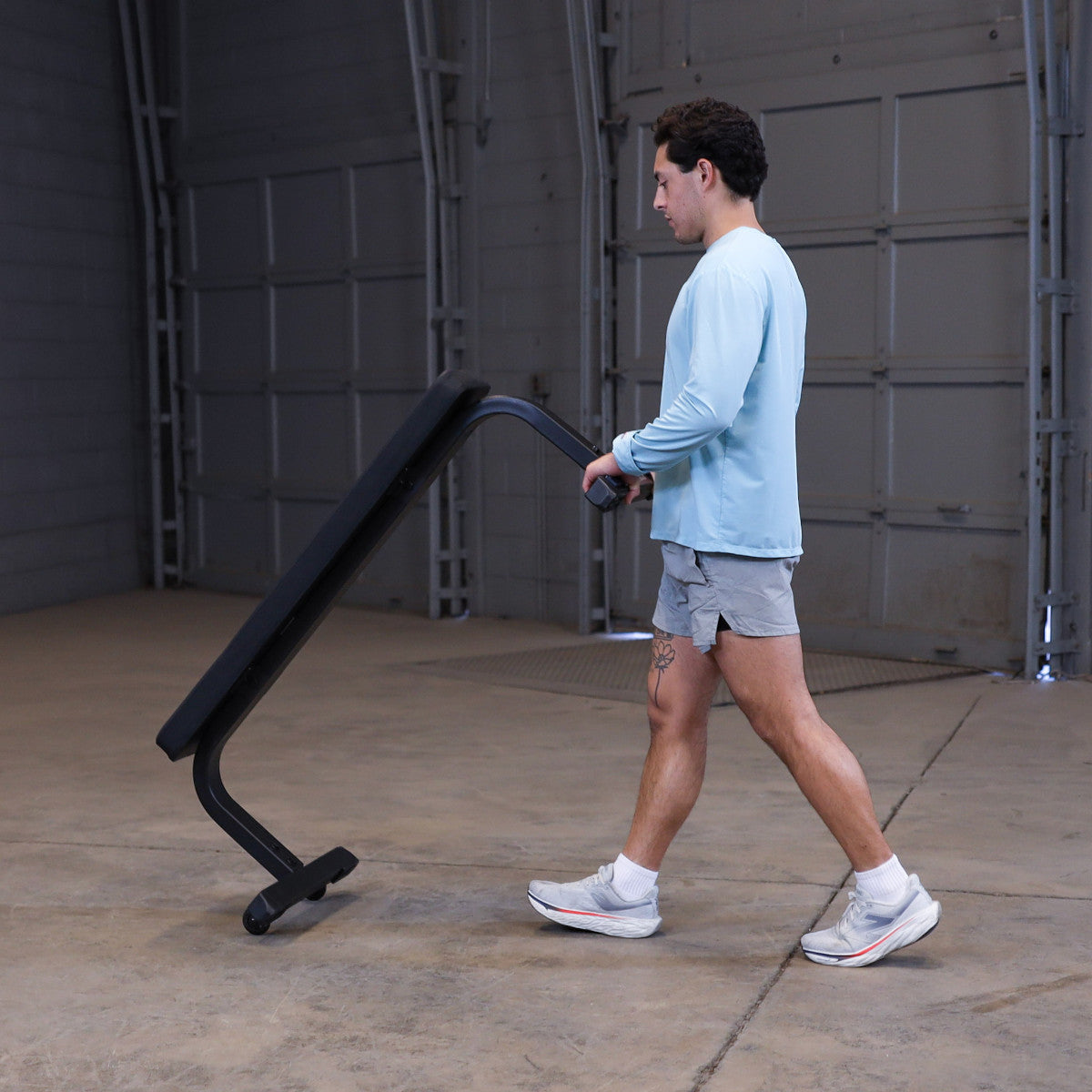 Body-Solid GFB350B Flat Bench man moving bench