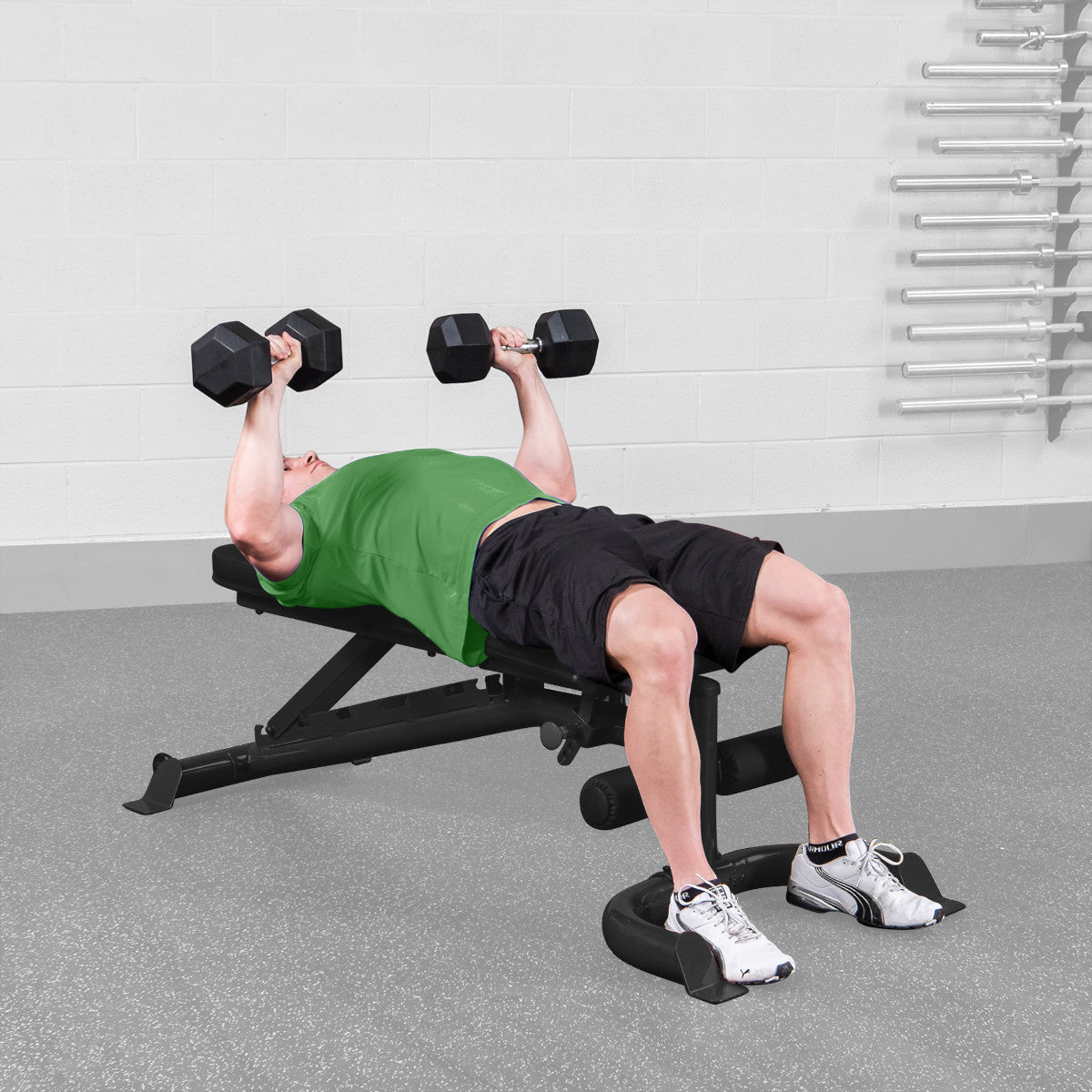 Body-Solid GFID100B Flat Incline Decline Bench man doing flat bench dumbbell press