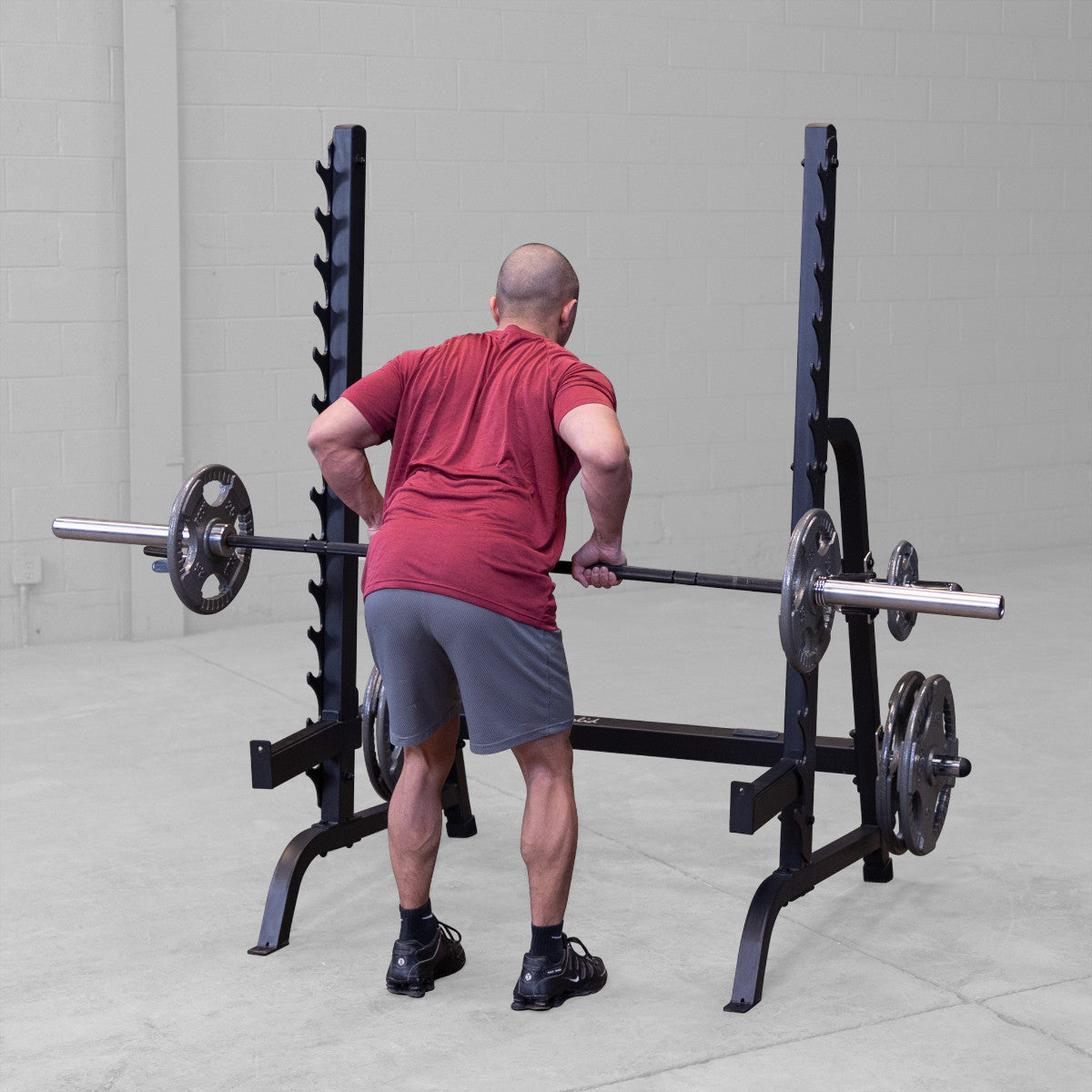 Body-Solid GPR370B Olympic Multi Press Rack man exercising