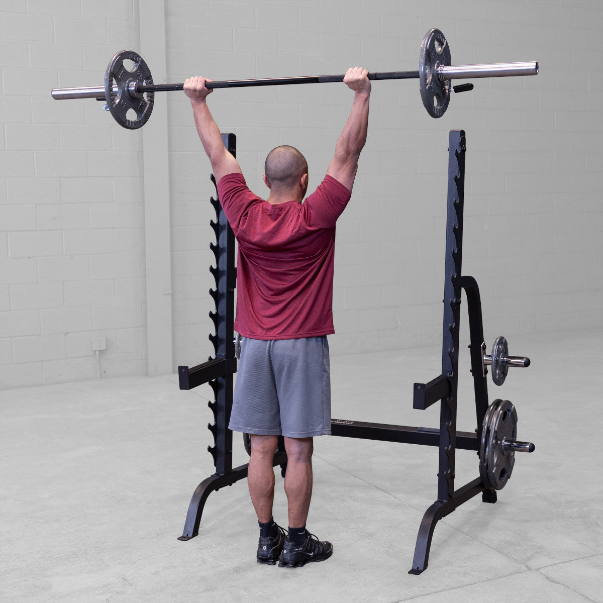 Body-Solid GPR370B Olympic Multi Press Rack man exercising