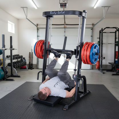 Body-Solid Body-Solid GVLP Vertical Leg Press man exercising in garage gym