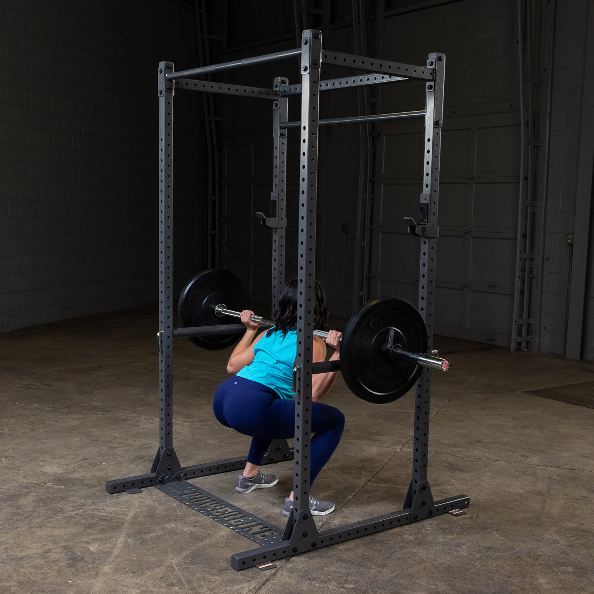 Body-Solid Powerline PPR1000 Power Rack with woman exercising