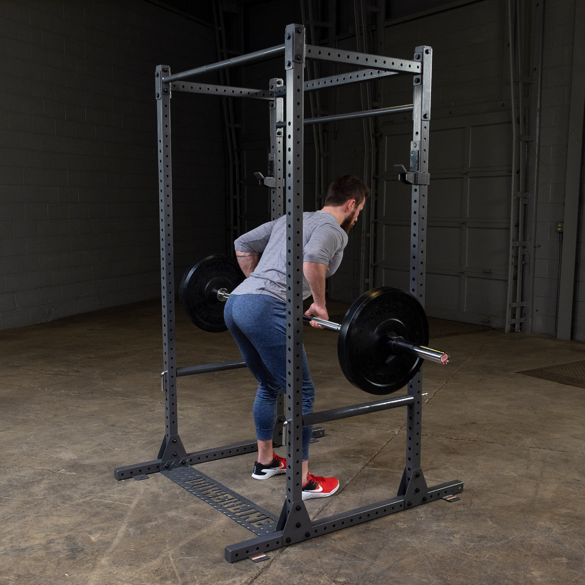 Body-Solid Powerline PPR1000 Power Rack with man exercising