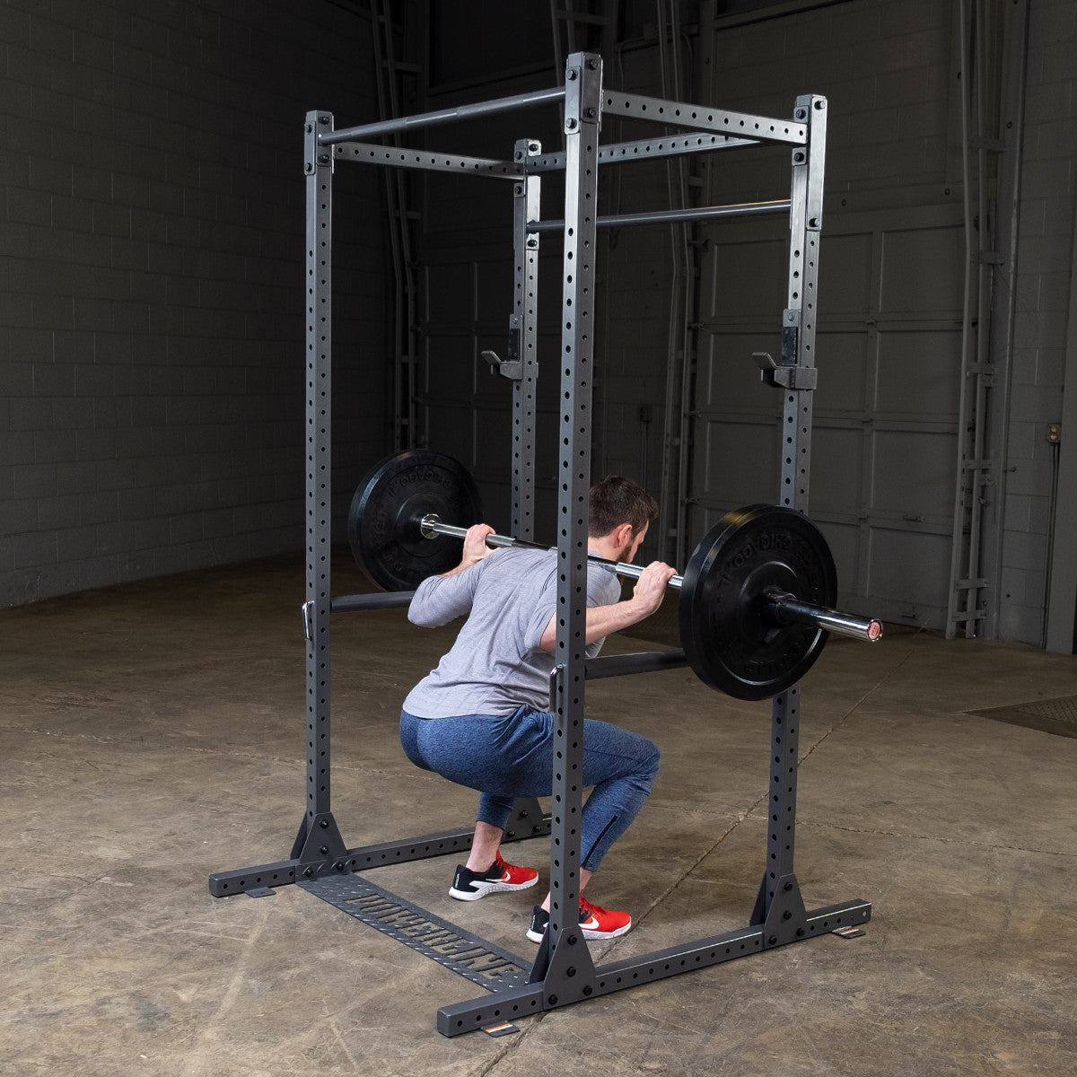 Body-Solid Powerline PPR1000 Power Rack with man exercising