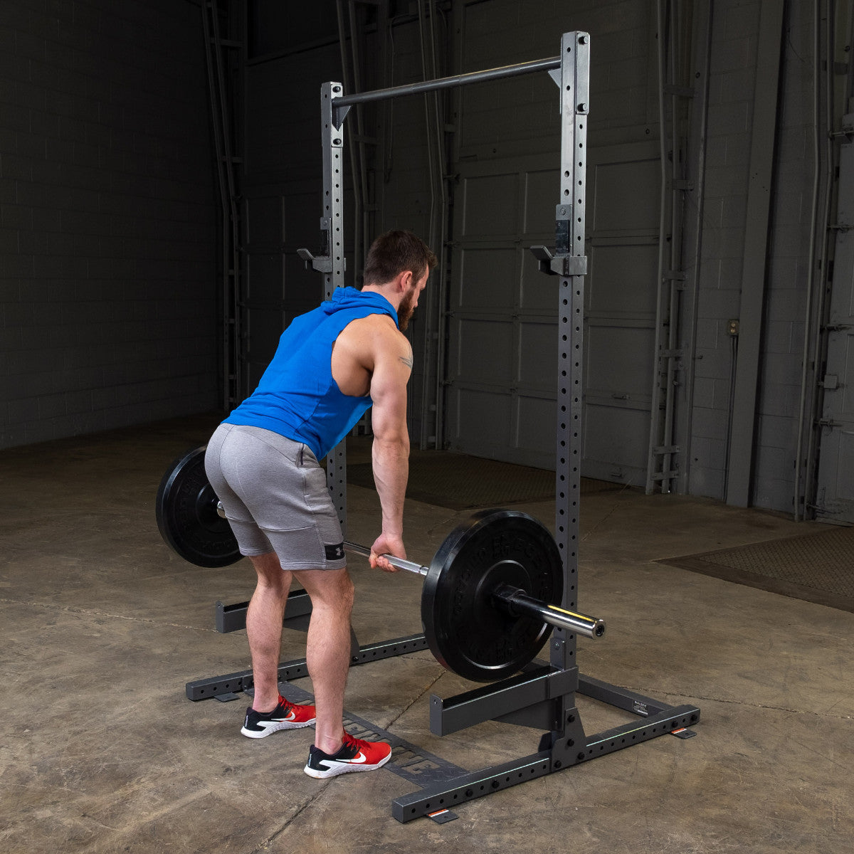 Body-Solid Powerline PPR500 Half Rack with man exercising