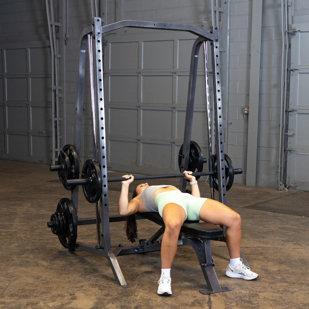 Body-Solid Powerline PSM200 Smith Machine woman exercising