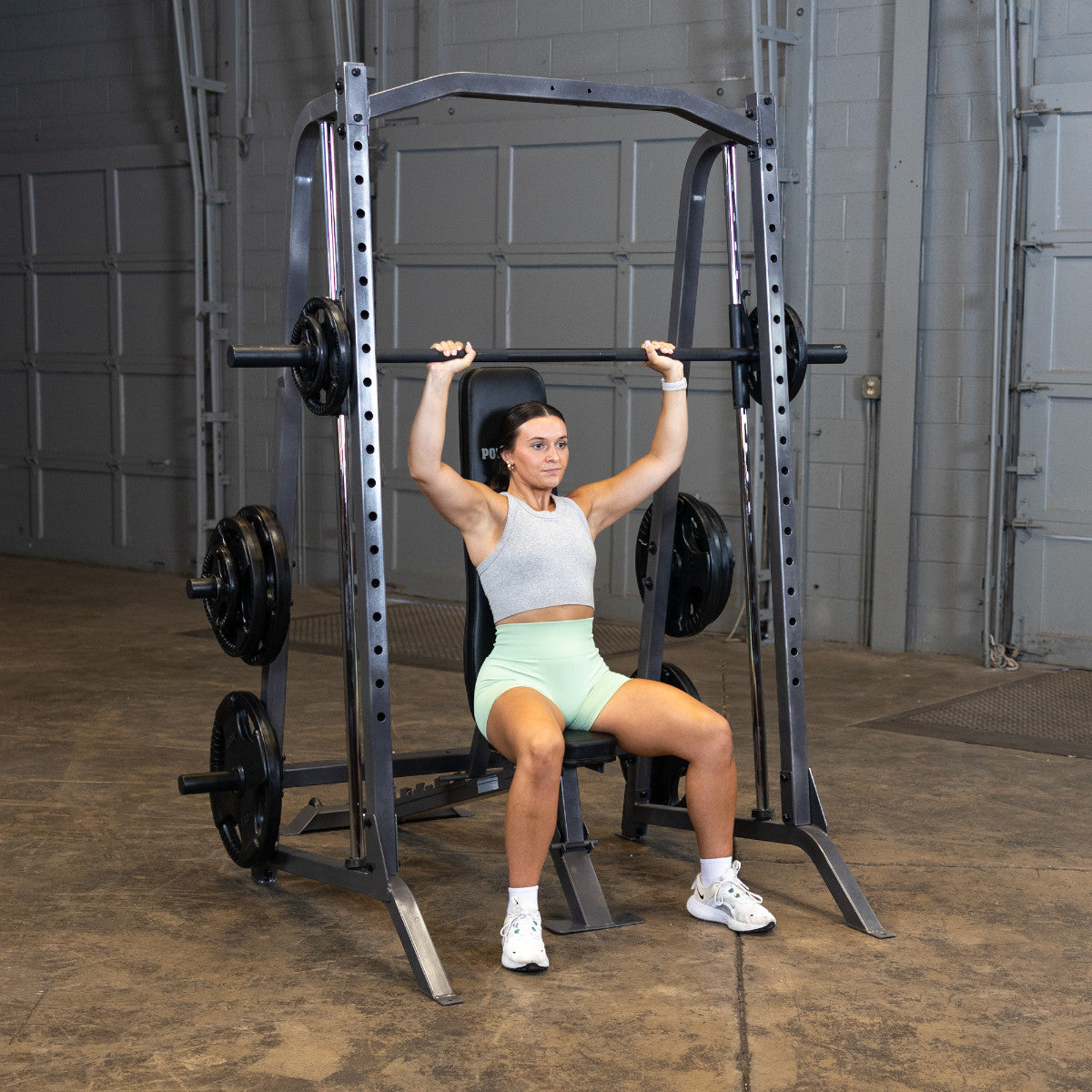 Body-Solid Powerline PSM200 Smith Machine woman exercising