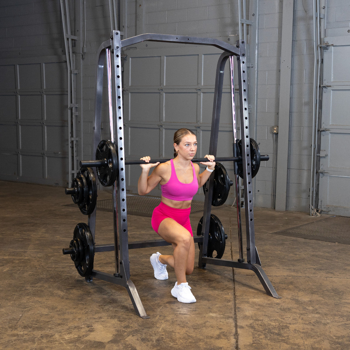 Body-Solid Powerline PSM200 Smith Machine woman exercising