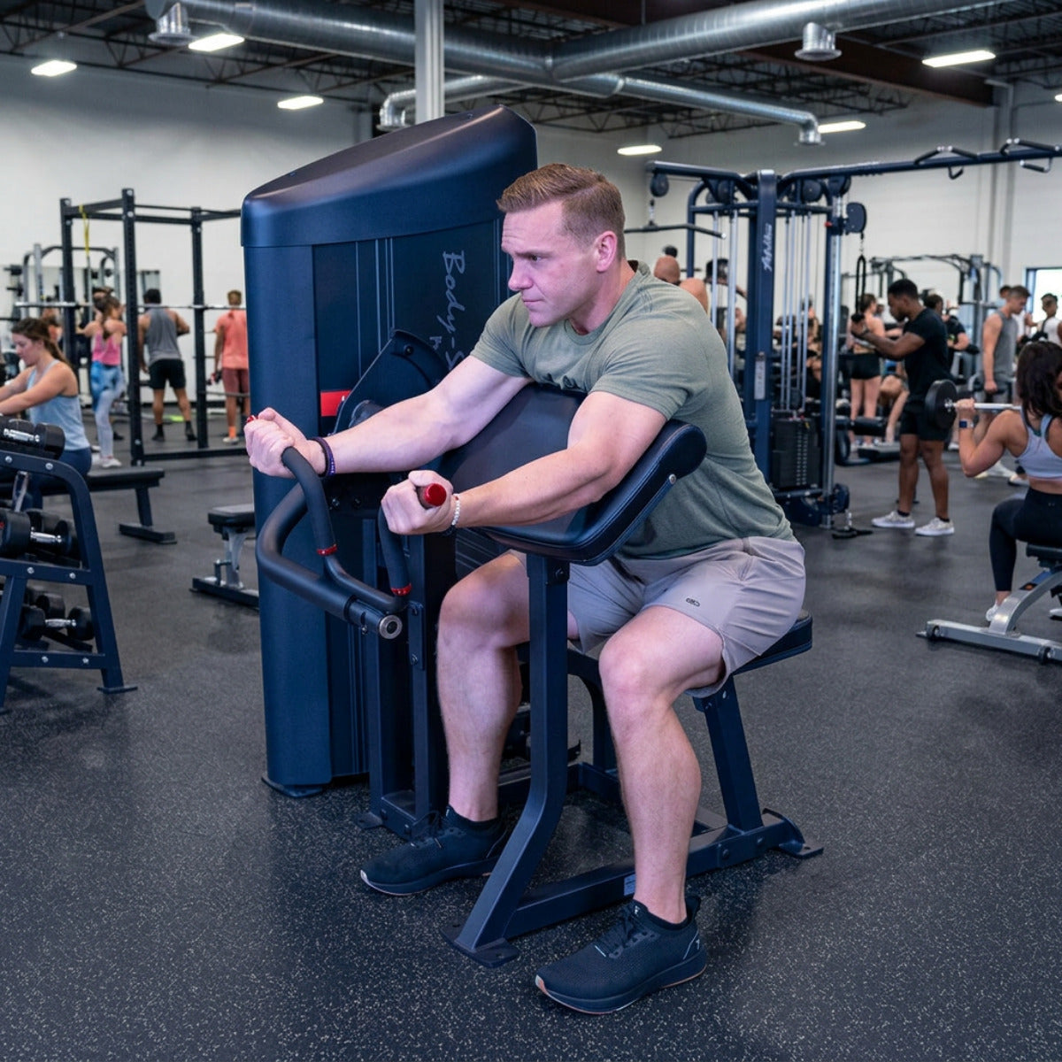 Body-Solid S2ACX Pro ClubLine Series 2 Arm Curl Machine in gym with man exercising