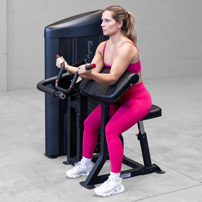 Body-Solid S2ACX Pro ClubLine Series 2 Arm Curl Machine in gym with woman exercising