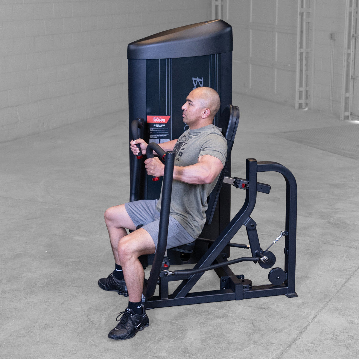 Body-Solid S2CPX Pro ClubLine Series 2 Chest Press Machine woman exercising in gym