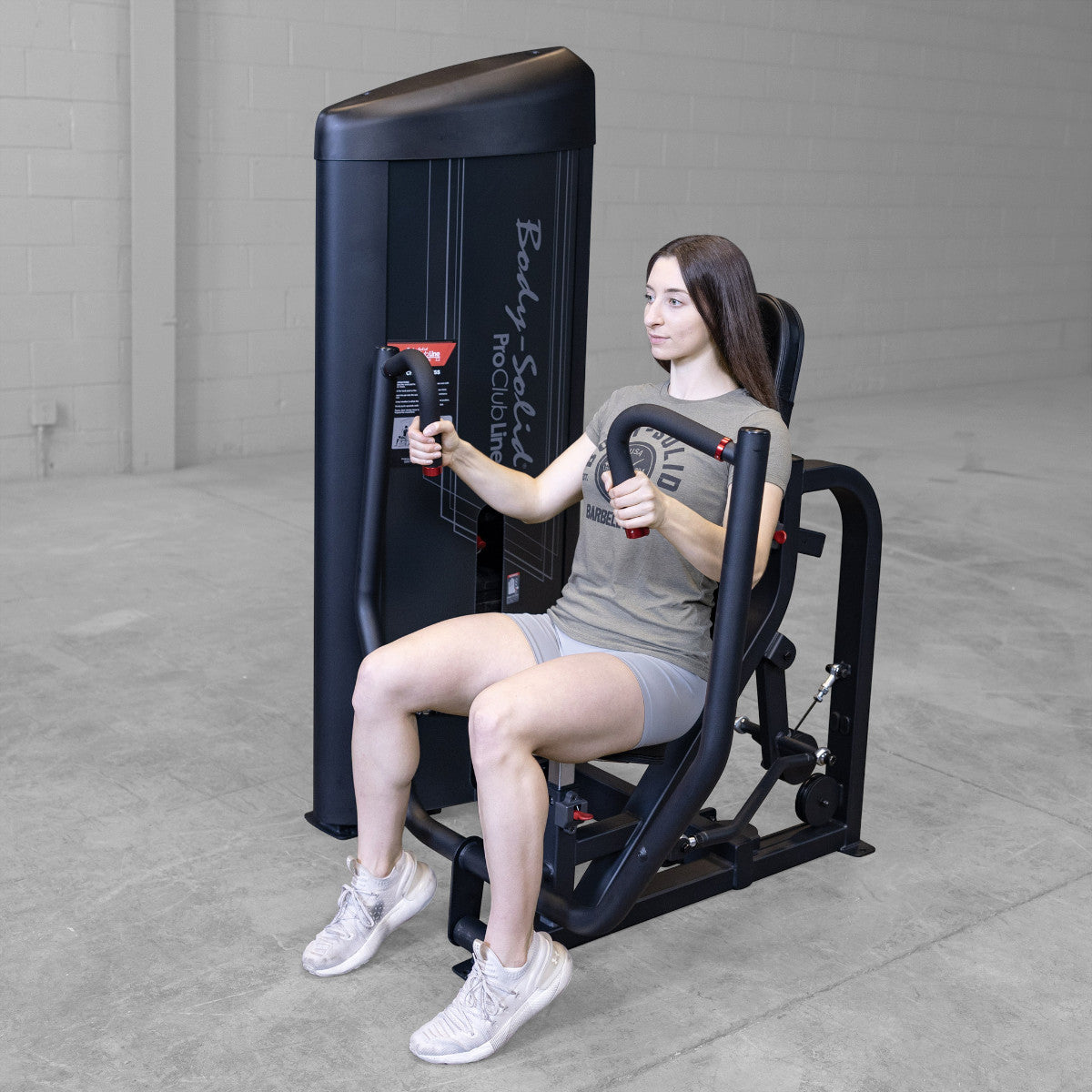 Body-Solid S2CPX Pro ClubLine Series 2 Chest Press Machine woman exercising in gym