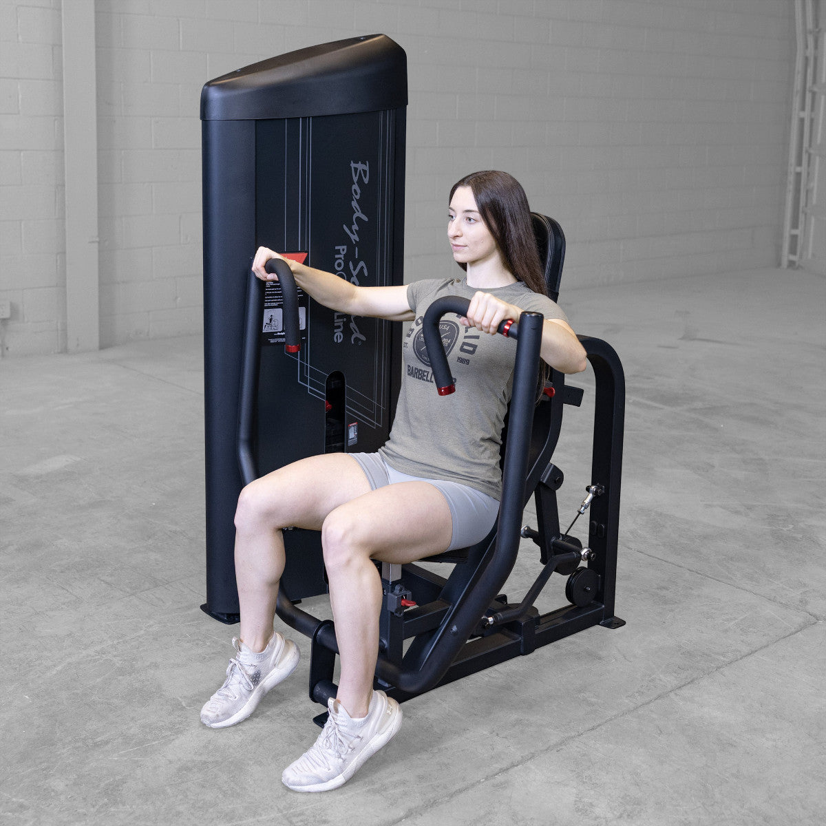 Body-Solid S2CPX Pro ClubLine Series 2 Chest Press Machine woman exercising in gym