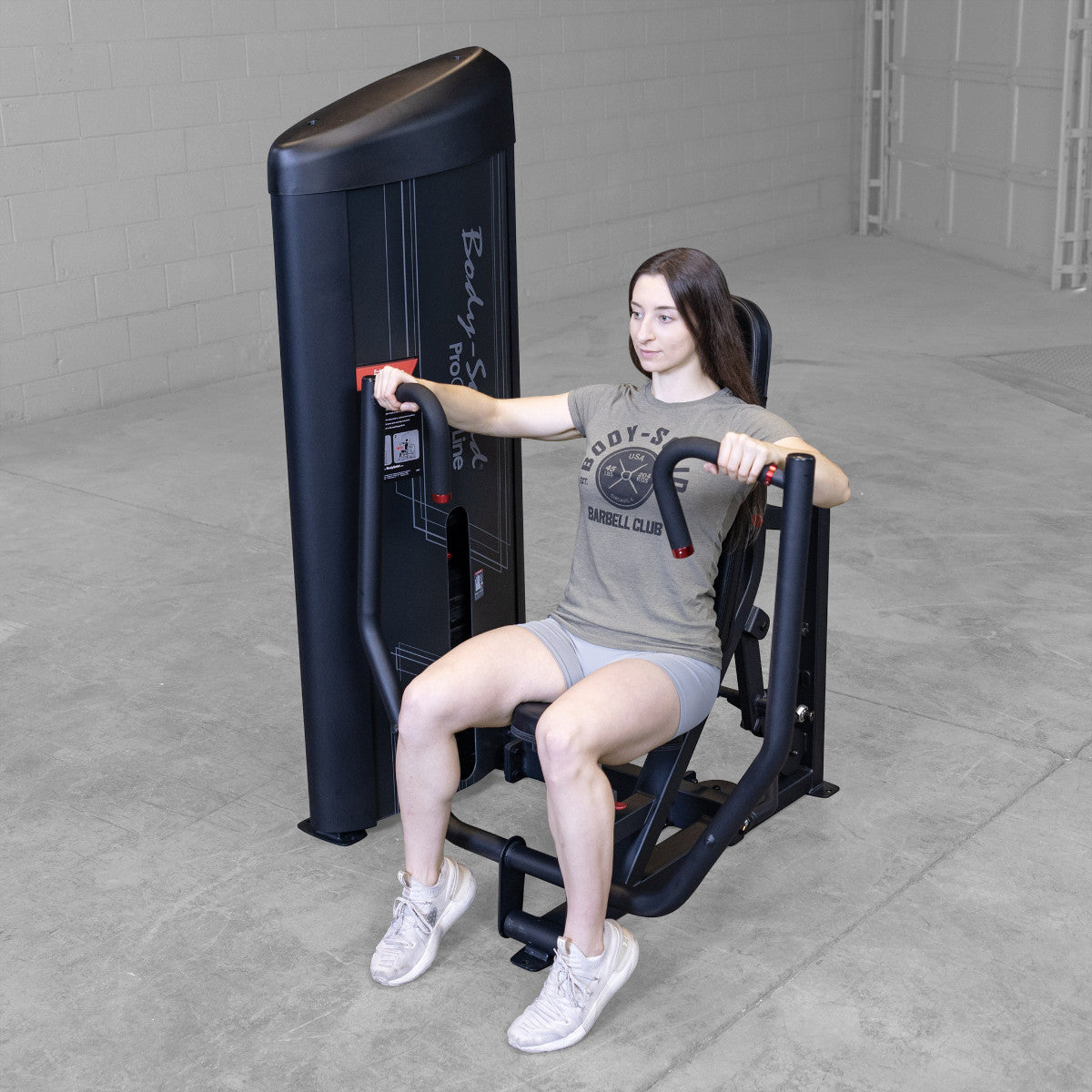 Body-Solid S2CPX Pro ClubLine Series 2 Chest Press Machine woman exercising in gym