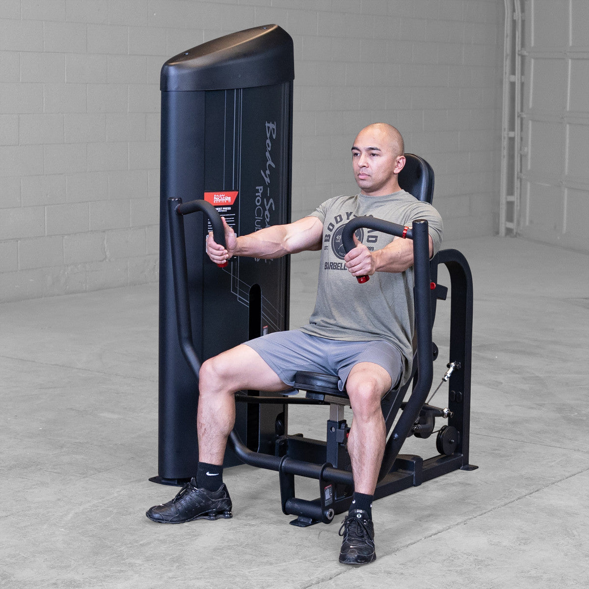 Body-Solid S2CPX Pro ClubLine Series 2 Chest Press Machine woman exercising in gym