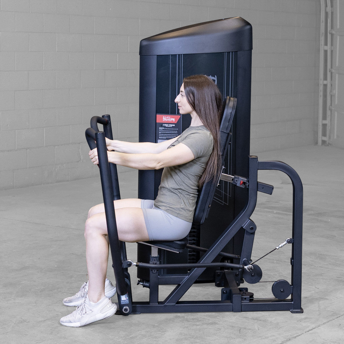 Body-Solid S2CPX Pro ClubLine Series 2 Chest Press Machine woman exercising in gym