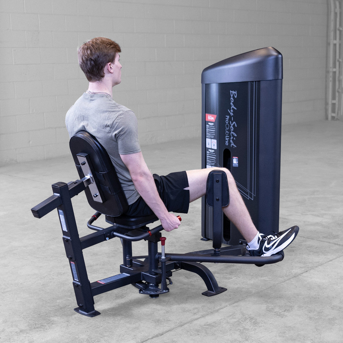 Body-Solid S2IOTX Pro ClubLine Series 2 Dual Inner Outer Thigh Machine in gym with man exercising